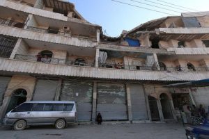 Residents stand on the balconies of a damaged building in Manbij, in Aleppo Governorate, Syria, August 9, 2016. REUTERS/Rodi Said