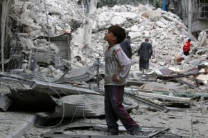 A boy inspects a damaged site after airstrikes on the rebel held Tariq al-Bab neighborhood of Aleppo, Syria. REUTERS/Abdalrhman Ismail